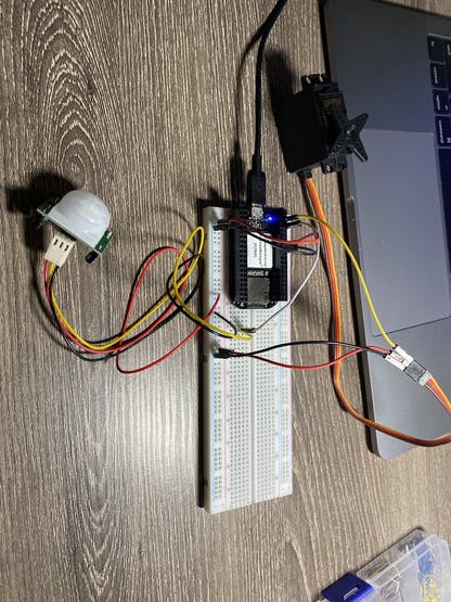 Photo of breadboard with just PIR sensor and Servo on it