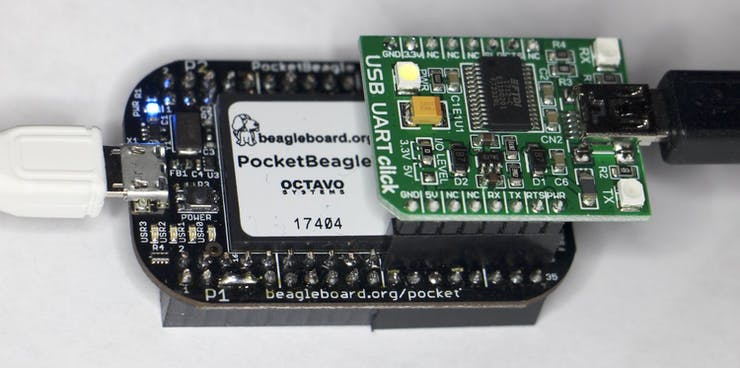 Plugging a UART click board into the PocketBeagle gives access to the serial console.