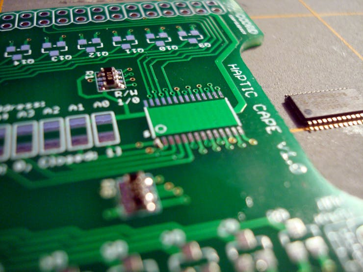 With chips like this, it's always good to setup your orientation beforehand. Make sure the registration marks on the PCB and the chip line up. Then go ahead and tin one of the pads. It's a little blurry, but the lower left pad is what I decided to tin. Finally like all the other parts, reheat the solder and slide the chip into place. Take your time getting the alignment just right. This is pretty much the only chance you have to get everything lined up.